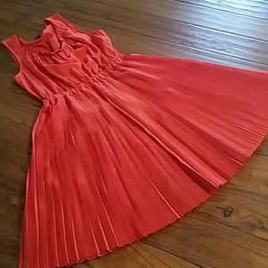 Pucker up for the bright orange dress.